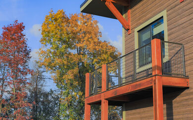 An exterior shot of the corner of a cabin, showcasing the deck.